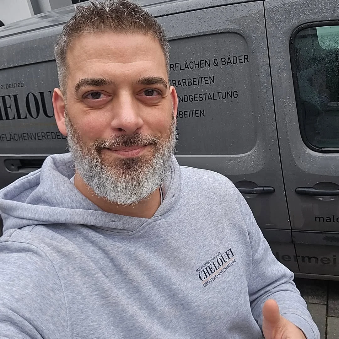 Mehdi Cheloufi - Malermeister vor Firmenfahrzeug